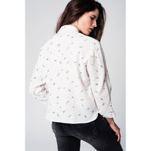 White blouse printed with black butterflies and dots