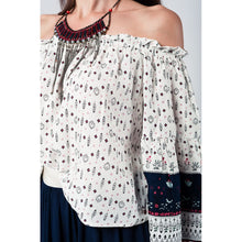 White navy off shoulders top with belled sleeves and floral print